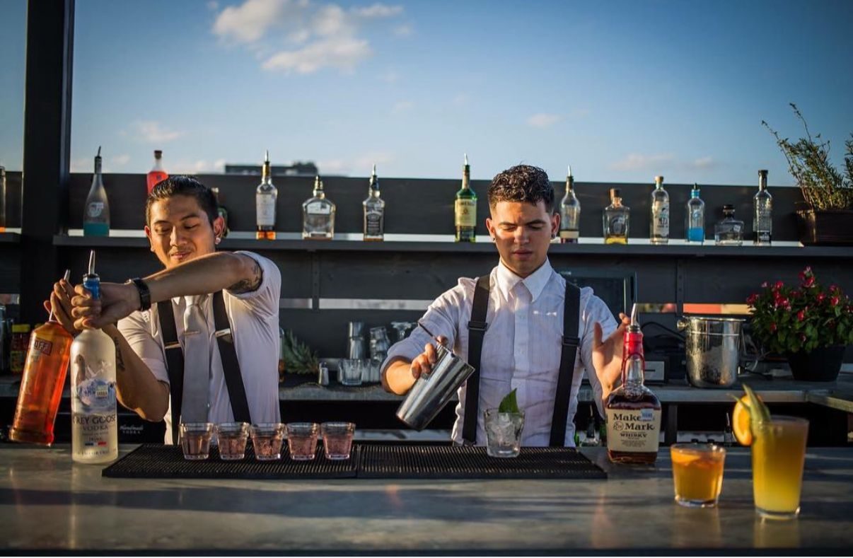 Roof 324 — bartenders at the rooftop bar at golden hour