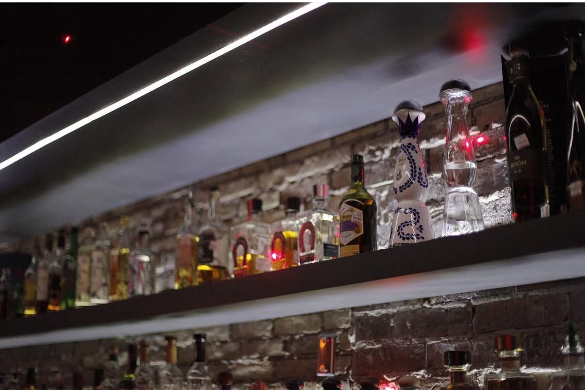 Roof 324 — bar shelf with bottles and LED lighting